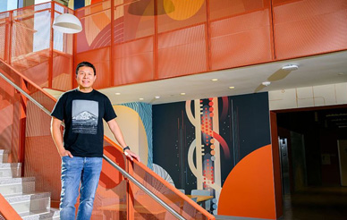 Brian Choi next to one of his campus murals