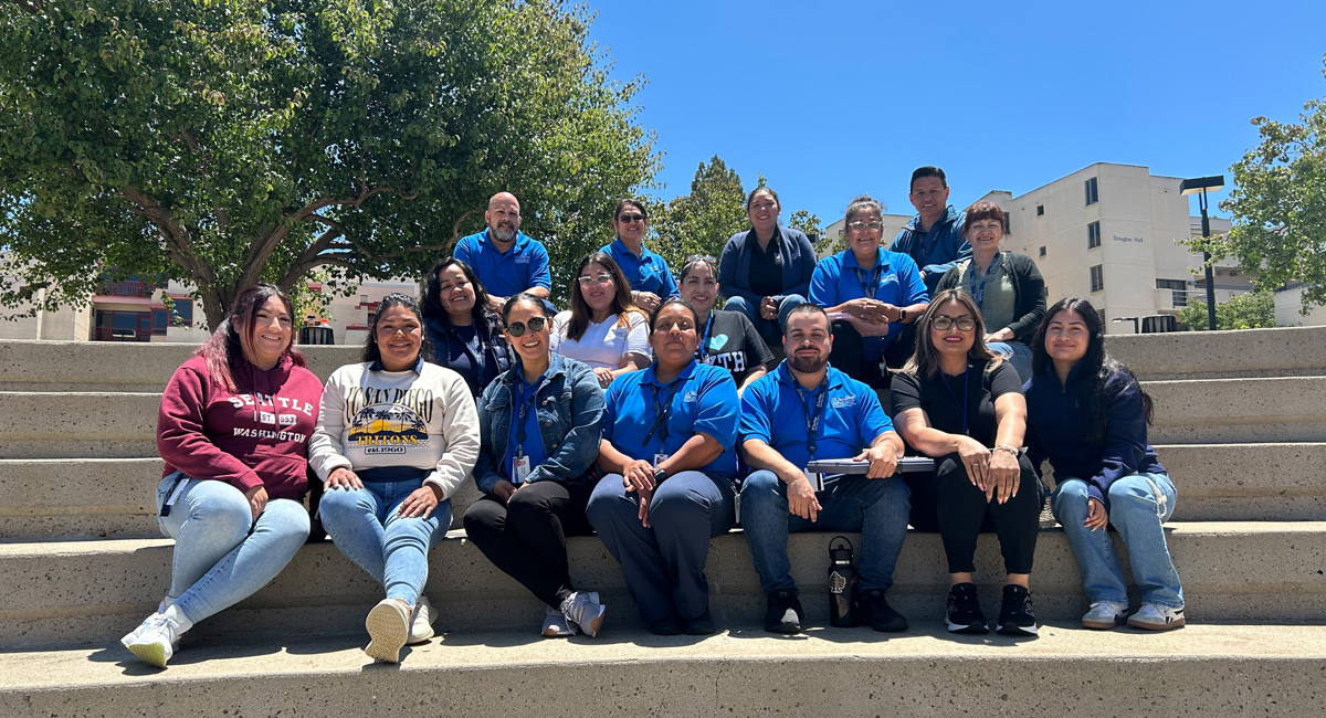 staff in cross training program taking group photo on steps